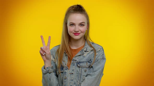 Pretty Stylish Smiling Girl Showing Victory Sign Hoping for Success and Win Doing Peace Gesture alt