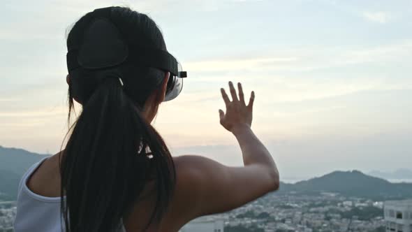 Woman Watching with Virtual Reality Device on Roof Top