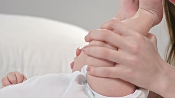 Loving Mom Kissing Feet of Baby alt