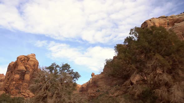 Panning view looking at desert cliffs as they move by alt