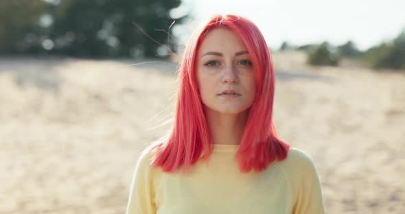 Shot of Face of Calm Beautiful Girl with Pink Hair Blowing in the Wind Freckles on Her Face Long alt
