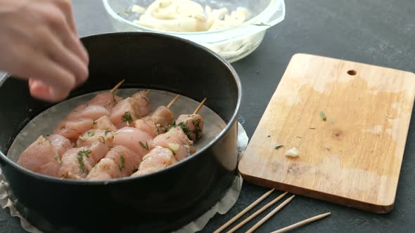  Woman's Hand Putting Marinated Shashlik From Chicken Meat in a Pan