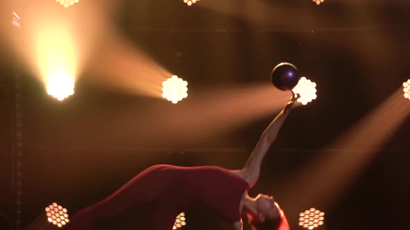 Sports Girl Gymnast Performs Acrobatic Exercises with Ball and Does Stretching, Showing the alt