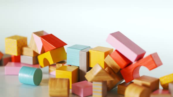 Construction of castle from colorful wooden blocks. Toy playful building.