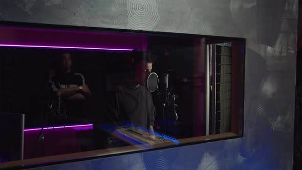 Inspired Cool African American Hip Hop Artist Singing Into Mic Recording Track in Music Studio alt
