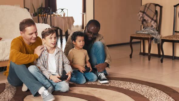 Multiracial fathers and sons playing video games