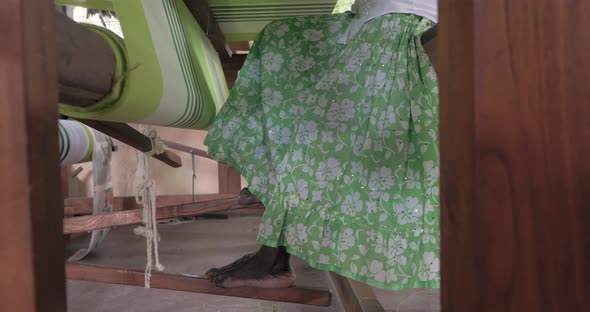 A Footage of a Woman Using Loom in a Traditional Asaian Factory