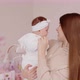 A Happy Mother Holds A Newborn Baby And Talks To Her - VideoHive Item for Sale