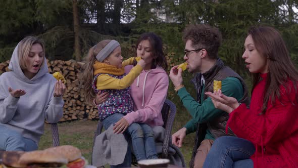 Group of Joyful Young People Enjoying Outdoor Summer Picnic Meal, BBQ Party