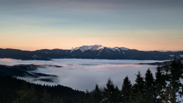 Time Lapse Cloud Inversion Moving in Mountain Valley With Pine Forest in the Foreground
