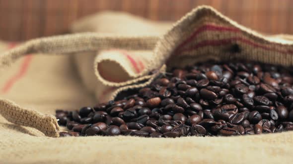 Closeup of Dark Beans of Freshly Roasted Coffee in Ecofriendly Burlap Bags