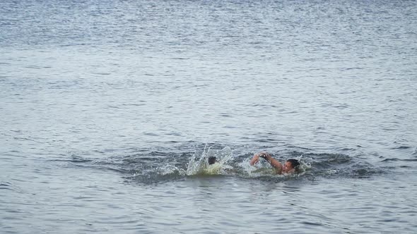 Two Guys Competing In Speed Swim In the Lake