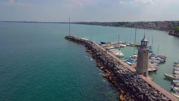 Aerial View of Boats and Lighthouse in Lake Garda, Italy alt