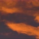 Yellow-Orange Clouds Glowing at Sunset Floating Across Dramatic Purple Sky - VideoHive Item for Sale