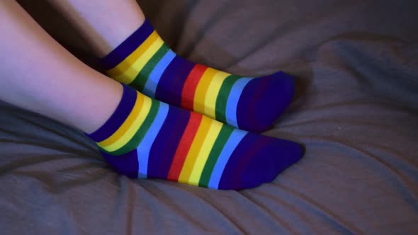 Putting on rainbow colored socks alt