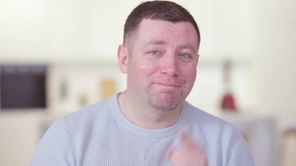 Portrait of Cheerful Positive Caucasian Man Talking Pointing at Camera and Showing Thumbs Up alt