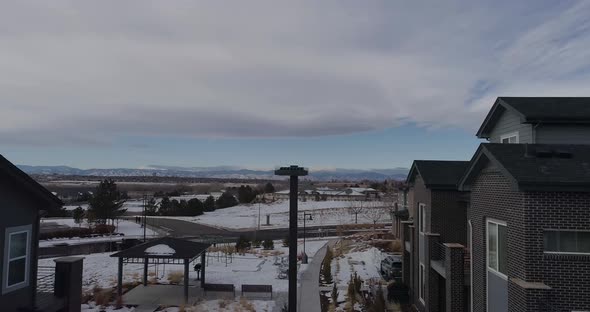 A suburban neighborhood with a rocky mountain view during winter 2021 alt