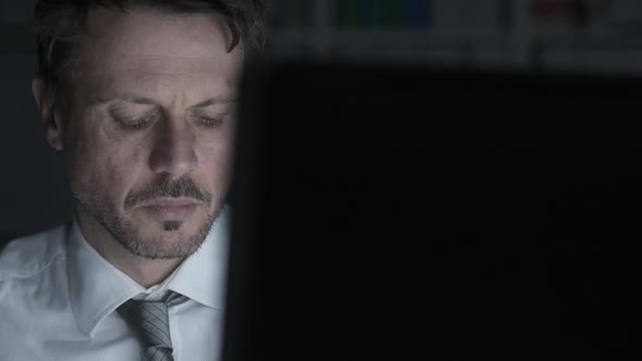 Businessman working with a computer and having neck pain