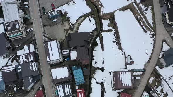 aerial top down of snow melting on the ground in nozawa onsen village nagano japan alt
