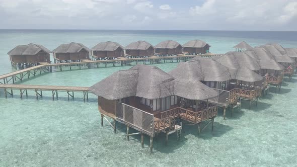 Aerial view of luxury bungalows on water, Island resort villas above sea, Maldives from drone