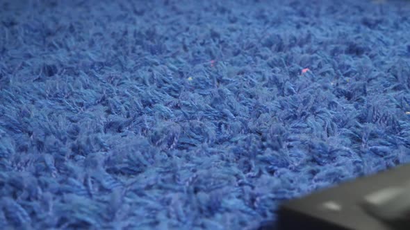 Cleaning Blue Carpet with Vacuum Cleaner