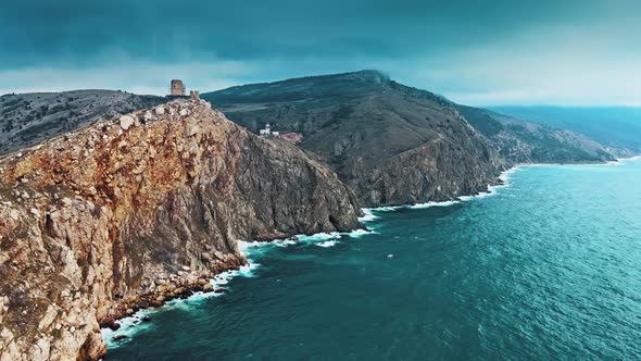 Aerial View of Ocean Waves Splashing in Rocks alt