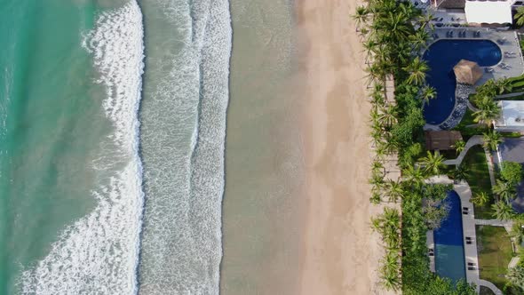 Aerial drone footage of sea waves reaching shore.