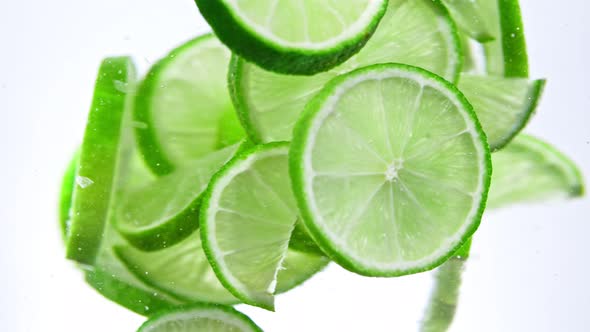 Super Slow Motion Shot of Fresh Lime Slices Rotating in Water at 1000 Fps alt
