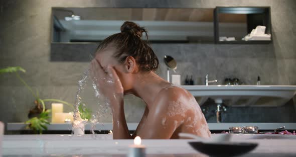 Caucasian woman taking bath in hotel alt