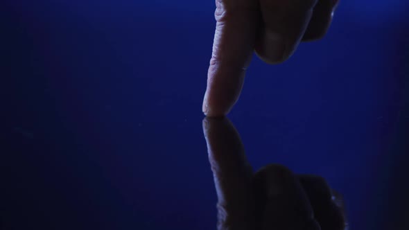 Thumb of caucasian man using digital interface applying fingerprint to touchscreen alt