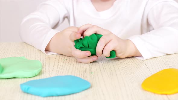 The childs hands are molded from plasticine Play Clay