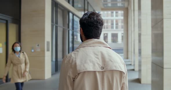 Back View of Man Waiting Wife From Work Outdoors in City alt