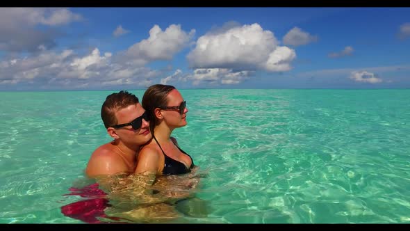 Teenage lovers suntan on luxury coastline beach wildlife by blue green sea and white sandy backgroun alt