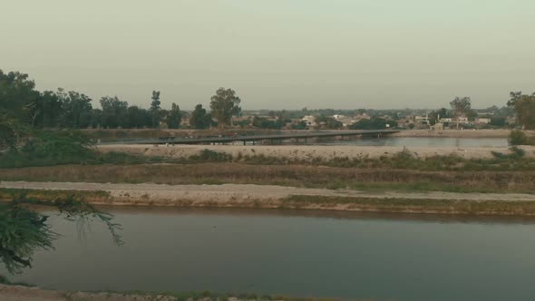 Aerial Over Waterway With Bridge In Background In Karachi, Pakistan. Dolly Forward alt