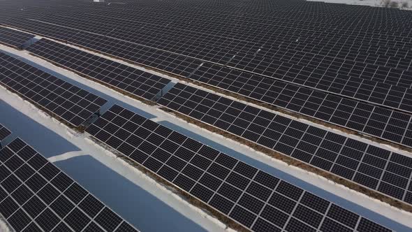 Closeup View From Top on Solar Panels Power Station in Desert at Winter Morning