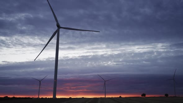 Spectacular Sunset with Modern Wind Turbines in Slowmo