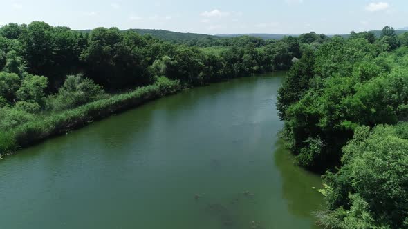 Aerial view of river and beautiful wild forest. alt