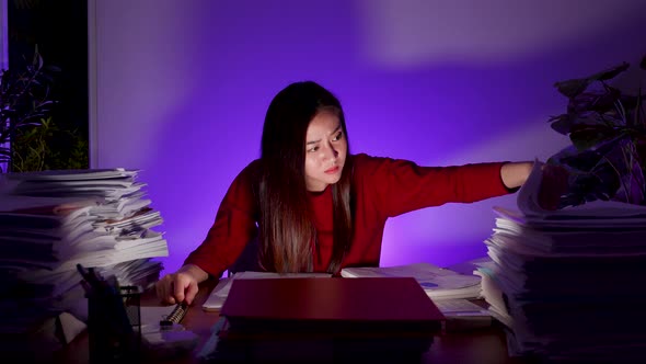 Workaholic people concept. Asian woman are overworked at night at home