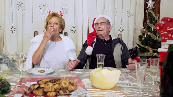 Senior Adult Couple Congratulating Christmas in Front of the Camera