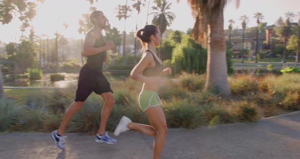 Athlete Couple Jogging In The Park alt
