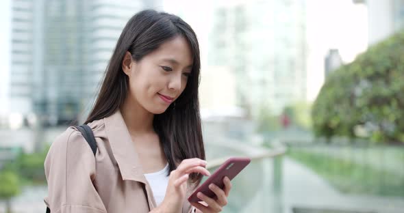 Woman use of cellphone at outdoor alt