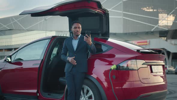 Male Entrepreneur Having Working Meeting Through Video Call on Smartphone While alt