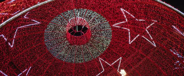 Low angle view of a giant red ball installation for Christmas holiday season. alt