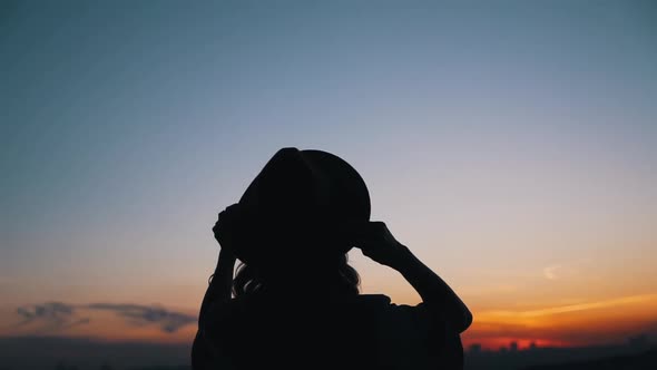 Girl Wears a Hat at Sunset