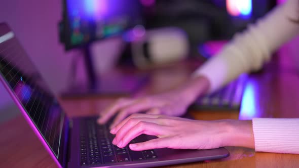 Gamer and E-Sport online of Asian woman playing online computer video game with lighting effect alt