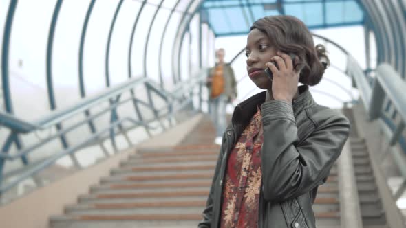 Cute African American Girl Texting on Phone Attended on Screen of Tablet, Afro Female, Beautiful alt