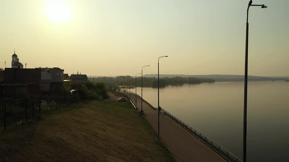 Aerial View of Embankment of River in Town at Sunset