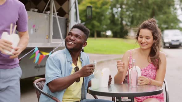 Happy Friends with Drinks Eating Wok at Food Truck  alt