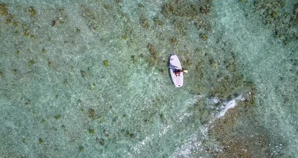 Natural fly over clean view of a white sandy paradise beach and blue water background alt