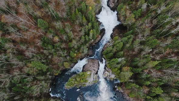 Aerial shot of autumn forest and running water between the shores in Aguasabon Falls,Ontario,Canada alt